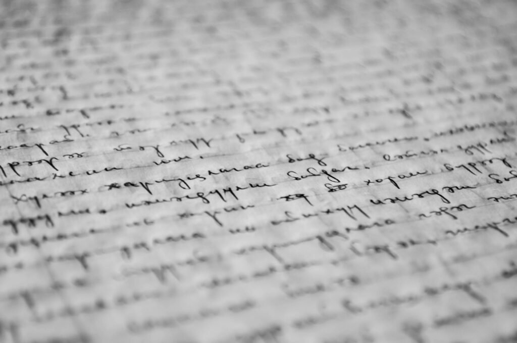 pexels-photo-261763-261763 Close-up of vintage handwritten text on old paper, showcasing detailed penmanship and texture.